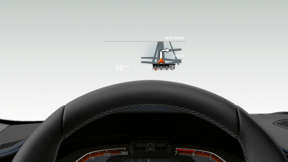 Sistemul BMW Head-Up Display al BMW Seria 3 Sedan. Imagine frontală în prim-plan cu jumătate din volanul şi parbrizul BMW Seria 3 Sedan cu BMW Head-Up Display.