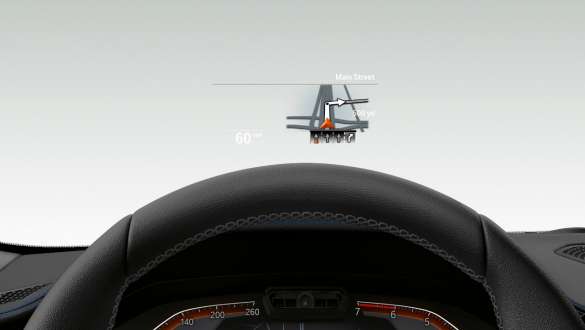 Sistemul BMW Head-Up Display al BMW Seria 3 Sedan. Imagine frontală în prim-plan cu jumătate din volanul şi parbrizul BMW Seria 3 Sedan cu BMW Head-Up Display.