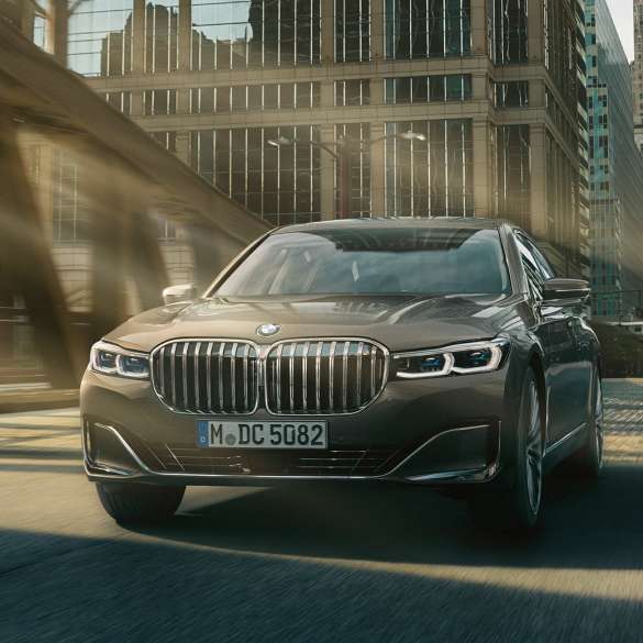 Sistemele de asistare a conducătorului auto ale BMW Seria 7 Sedan Sisteme de asistare a conducătorului auto: BMW Seria 7 Sedan rulând în faţa unui peisaj urban