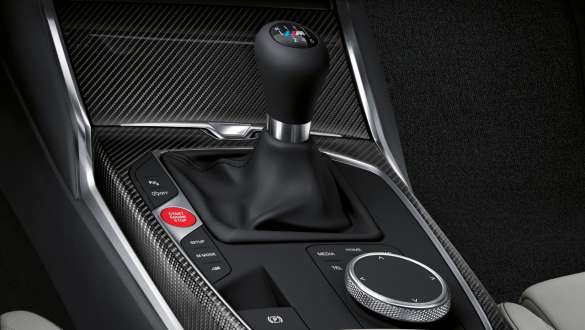 Transmisie manuală M şi tracţiune spate BMW M4 Coupé G82 2020 Imagine în prim plan cu consola centrală şi cu schimbătorul de viteze al BMW M4 Coupé G82 2020 cu transmisie M manuală cu 6 trepte şi tracţiune spate