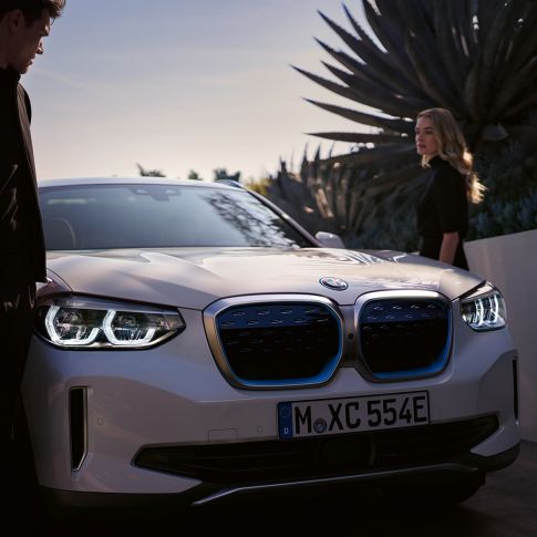 Imagine cu trei sferturi din partea frontală a BMW iX3, G08, cu grilă frontală BMW i Imagine cu trei sferturi din partea frontală a BMW iX3, G08, 2020, în Alb Mineral metalizat, cu grilă frontală BMW i