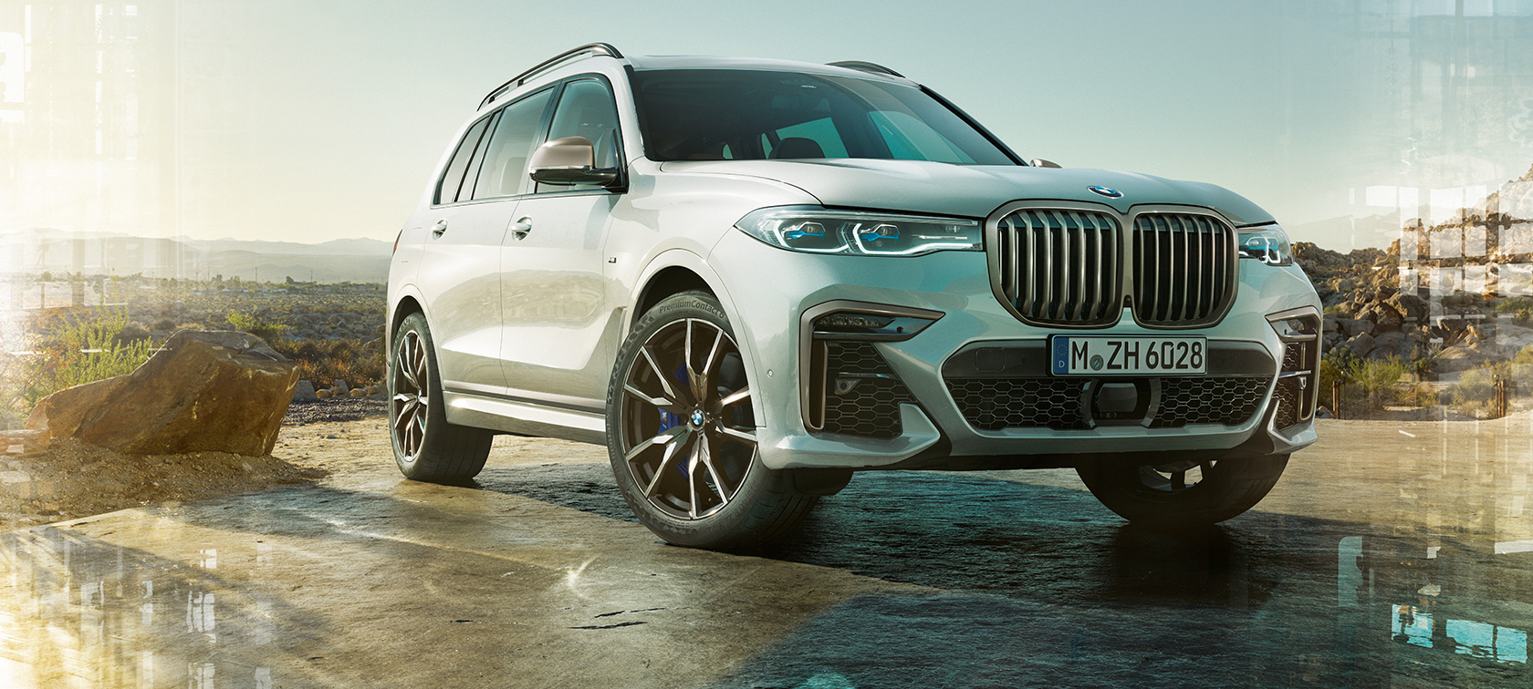 Imagine cu trei sferturi din partea frontală a unui BMW X7 M G07 2019 Imagine cu trei sferturi din partea frontală a unui BMW X7 M G07 2019, în Alb Mineral, staţionând