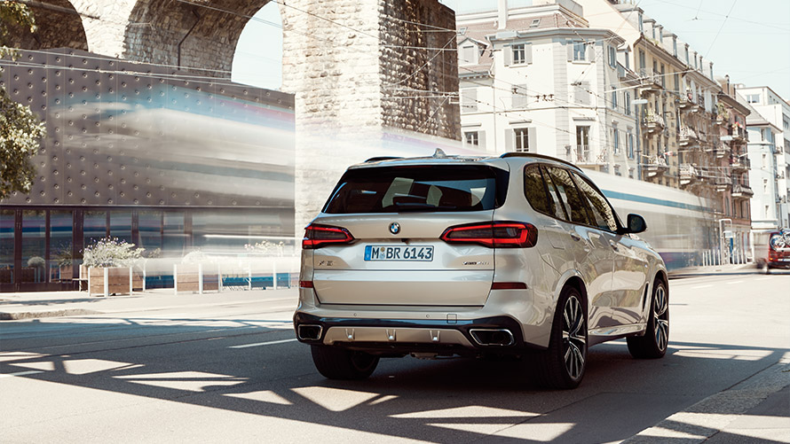 Imagine cu trei sferturi din partea din spate a BMW X5 G05 din a patra generaţie staţionând în faţa unei clădiri Imagine cu trei sferturi din partea din spate a BMW Seria X BMW X5 G05 din a patra generaţie staţionând în faţa unei clădiri