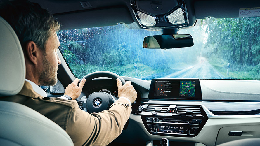 Informaţii din trafic în timp real Un bărbat folosind Informaţiile din trafic în timp real pe ecranul automobilului său BMW